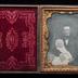 Seated man holding a baby daguerreotype, undated