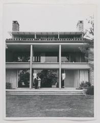 Albert M. and Elizabeth Greenfield standing in front of "Sugar Loaf" photograph, 1955