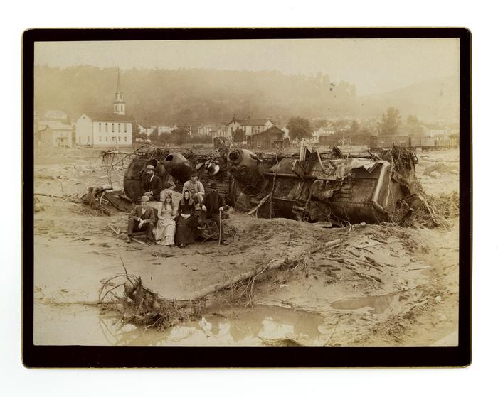 Group posed with wrecked train car, Johnstown Flood