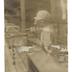 J. G. Brill Company plant interior showing female worker with power drill, photograph