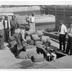 Men unloading liquor seized from a garbage scow