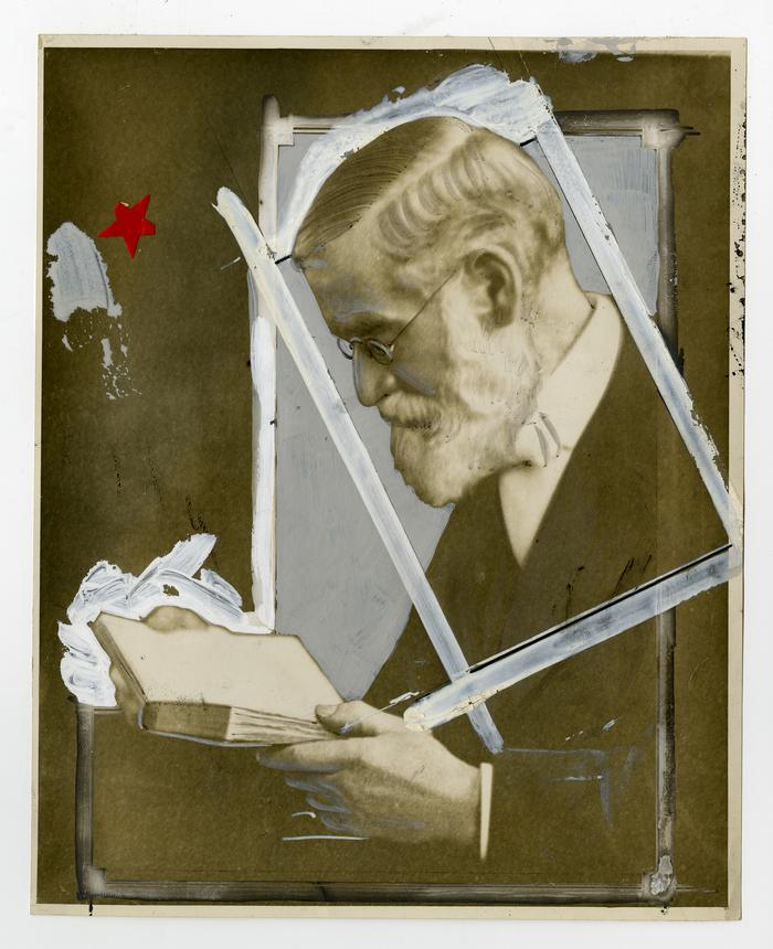 Photograph of Gilbert Cope looking at a book. Retouching, including the use of ink and whitener, evident.